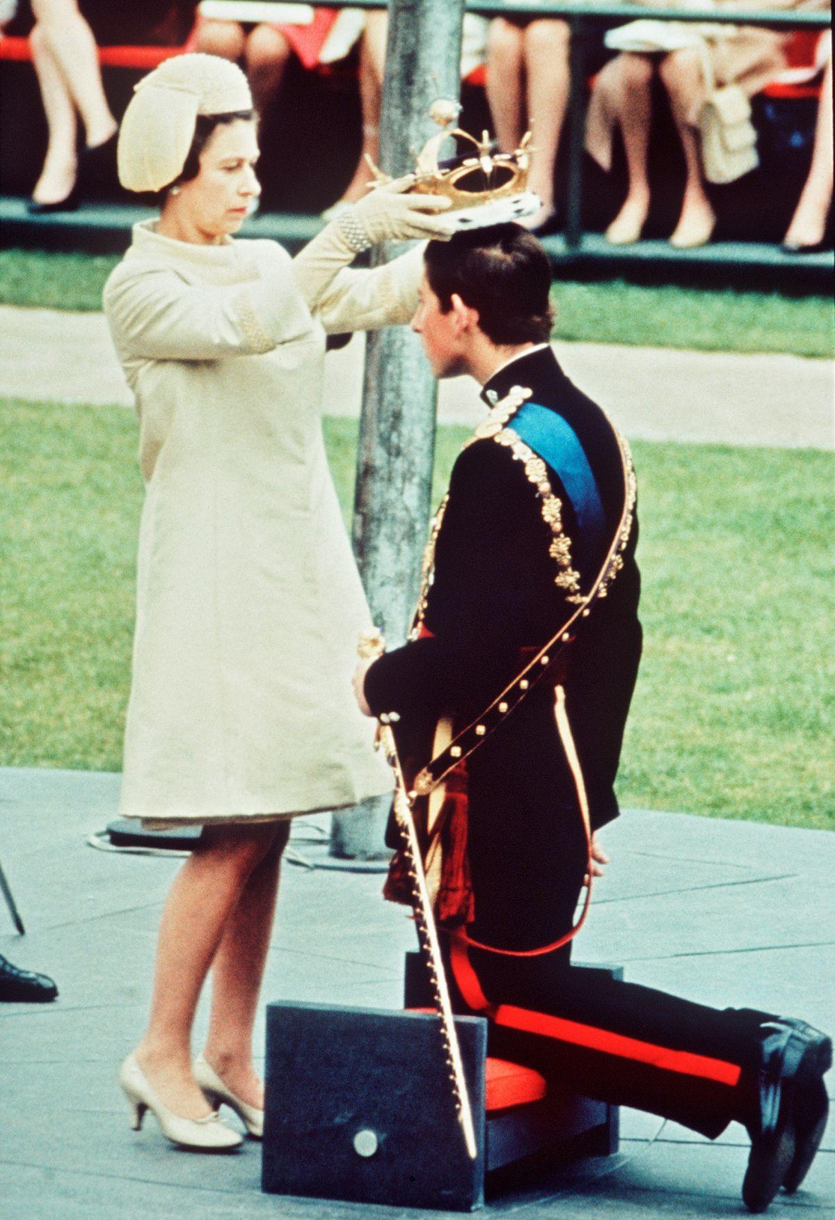 The late-Queen placing a crown on Charles' head during his 1969 investiture
